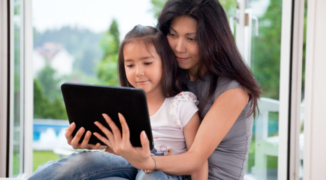 mom and daughter using tablet