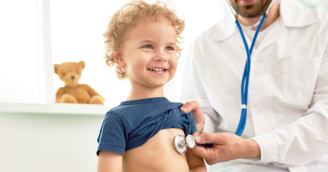 child with doctor checking heart beat